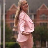 Female student in suit walking outside